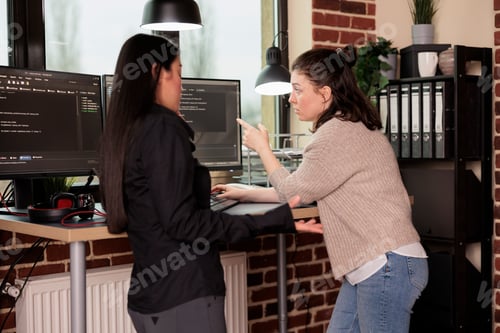 Preview: Diverse tech enginners developing javascript code and cloud computing