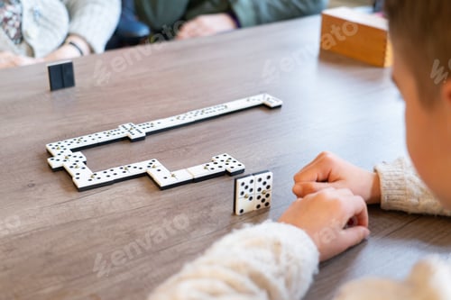 Preview: Boy playing dominoes with his great-grandmother in a nursing home