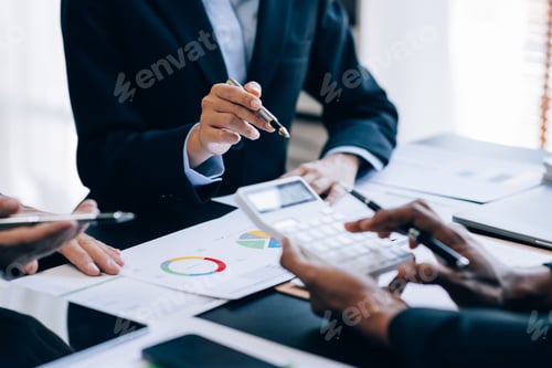 Preview: Close up view of businesspeople or accountant team working on financial investment on calculator in