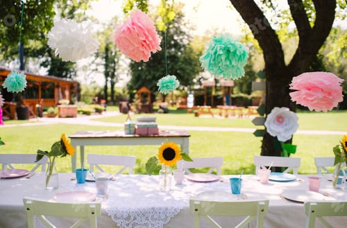 Preview: A table set for kids birthday party outdoors in garden in summer