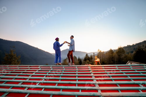 Preview: Man and woman enjoy beautiful sunset in the mountains