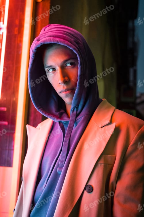 Preview: Young millennial hispanic man with red neon light reflection