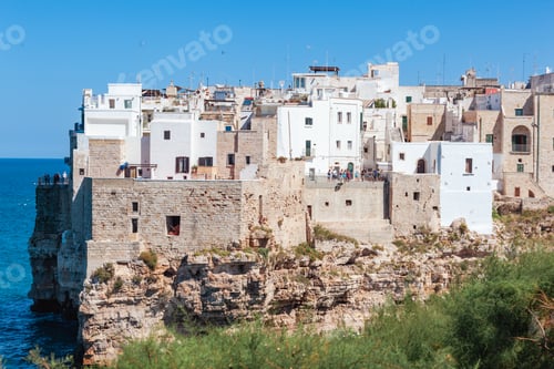Preview: Whitewashed cliffside dwellings perched above turquoise Adriatic waters in Polignano a Mare