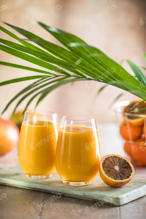 Preview: Two mango lassi or kesar milk in glasses. Indian healthy ayurvedic cold drink with mango.