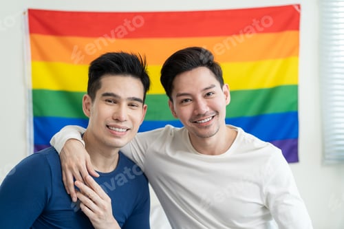 Preview: Portrait of Asian handsome man gay family holding LGBT flag and smile.