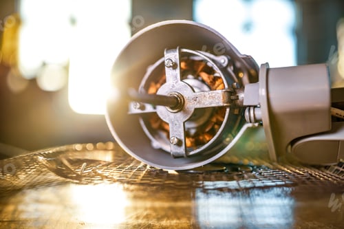 Preview: Close-up of iron motor from home cooling fan lies on a table