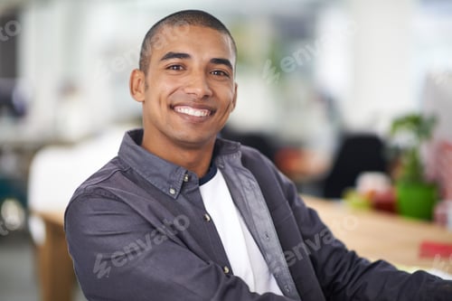Preview: Feeling filled with satisfaction. A smiling young designer in the office.