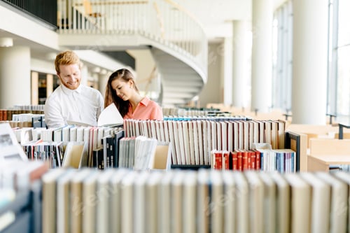 Preview: Two students reading and studying in library