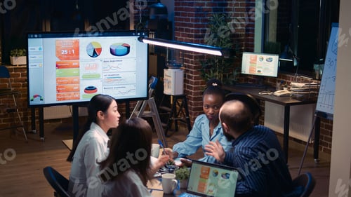 Preview: Diverse business team duscussing analytics report presentation in meeting
