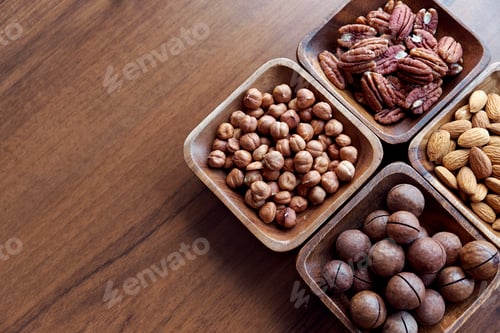 Preview: Wooden bowl with mixed nuts on table top view. Healthy food and snack
