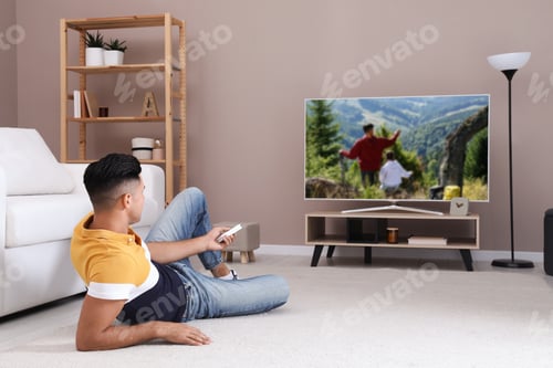 Preview: Man watching television at home. Living room interior with TV on stand