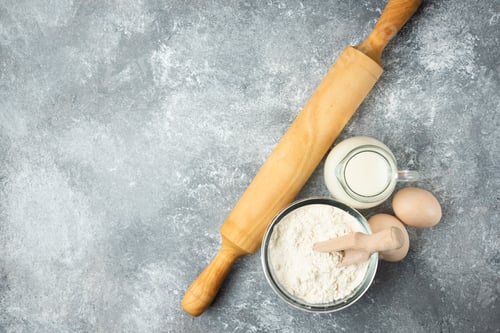 Preview: Flour, eggs, milk and rolling pin on marble background