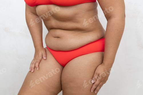 Preview: Unrecognizable overweight, fat woman in lingerie lean forward in pain, holding thighs and hips