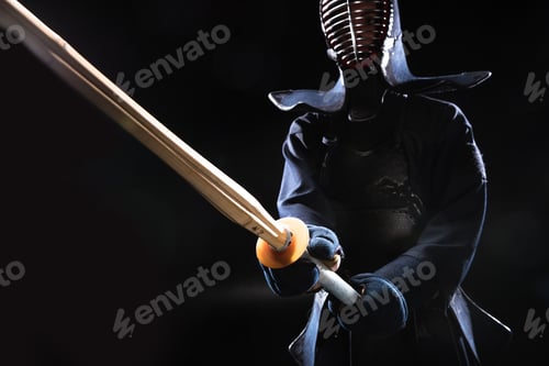 Preview: Kendo fighter in helmet holding bamboo sword on black