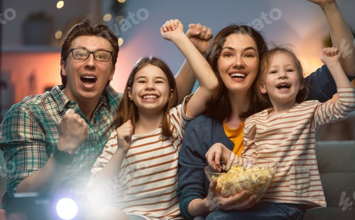 Preview: Mother, father and daughters spending time together.