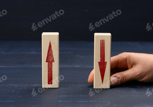 Preview: Female hand holds a wooden block with an upward arrow and down arrow