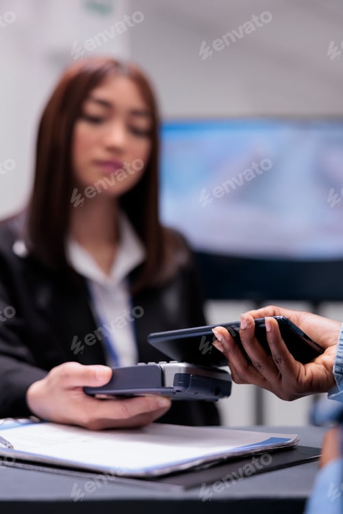 Preview: Young adult using credit card to pay checkup