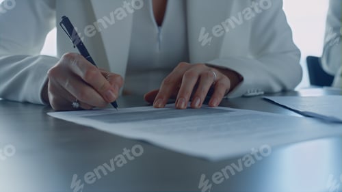 Preview: Woman Signs Document in Office with Business Pen