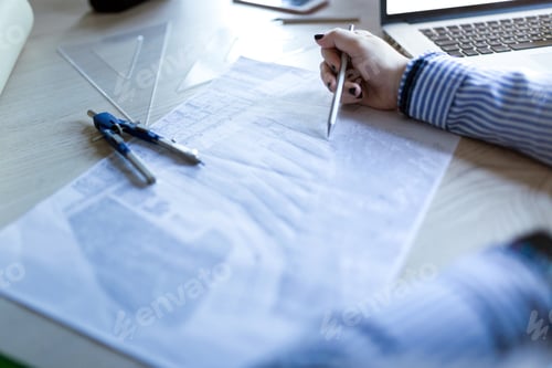 Preview: Young architect working at home drawing plans
