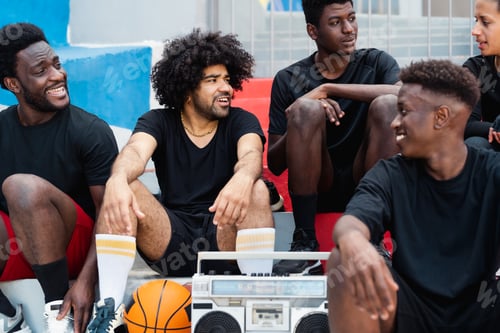 Preview: Young multiracial people having fun listening music with vintage boombox outdoor