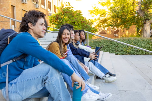 Preview: Diverse college students hanging out on campus stairs