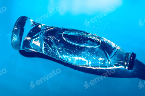 Preview: Water bottle close up on dark blue background