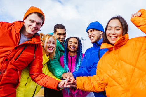 Preview: Multiracial group of young friends meeting outdoors in winter
