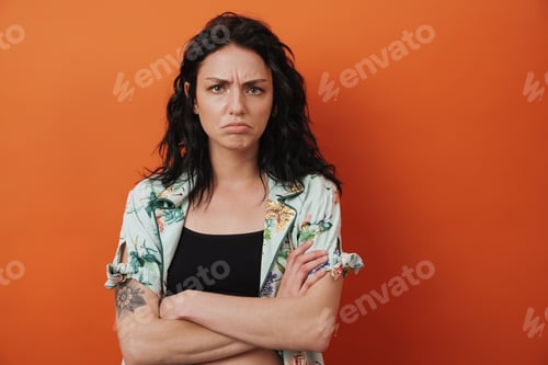 Preview: Displeased woman isolated over orange wall background