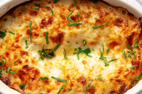Preview: Homemade Scalloped Potatoes with Cheese and Parley, top view. Close-up.