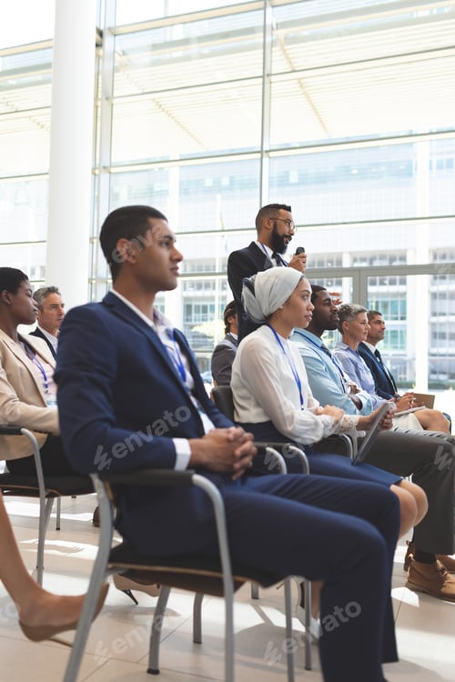 Preview: Businessman standing up in office building