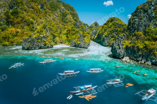 Preview: Aerial view of tourist boats in front of big Lagoon at Miniloc Island, El Nido, Palawan, Philippines