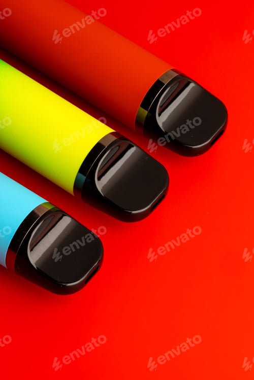 Preview: Colorful pens on a bright red background with black tips and caps showing