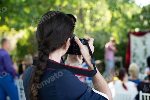 Preview: Photographer is a woman photographing a wedding ceremony