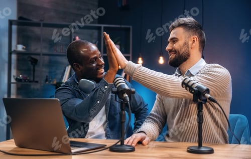 Preview: Modern technology, with laptop. Two radio presenters recording an audio broadcast in a studio