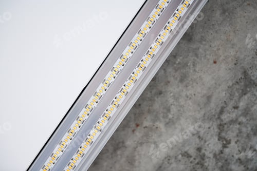Preview: Strip LED light with aluminum profile on stretch ceiling, close up. Home renovation concept