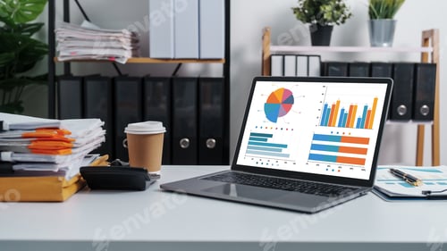 Preview: Laptop Displaying Charts and Graphs on an Office Desk