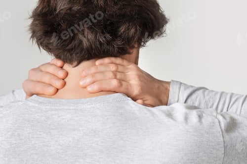 Preview: Neck pain concept. Man rubs sore spot