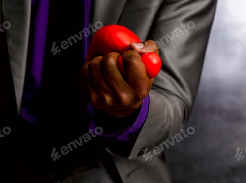 Preview: Business man squeezing stress ball