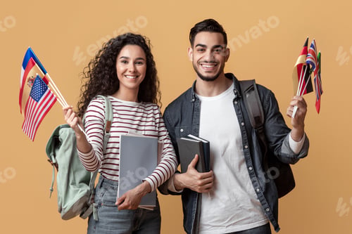 Preview: Education Abroad. Young Arab Man And Woman Holding Stack Of International Flags