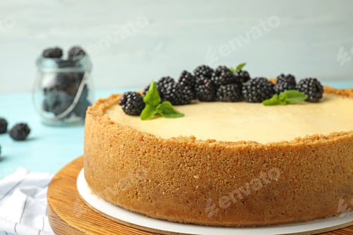 Preview: Delicious cheesecake decorated with blackberries on table