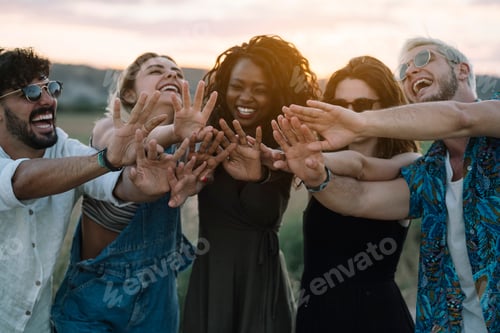 Preview: Young people reaching out hands in nature