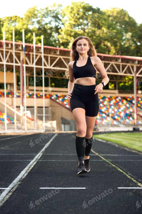 Preview: young, athletic girl running on the track