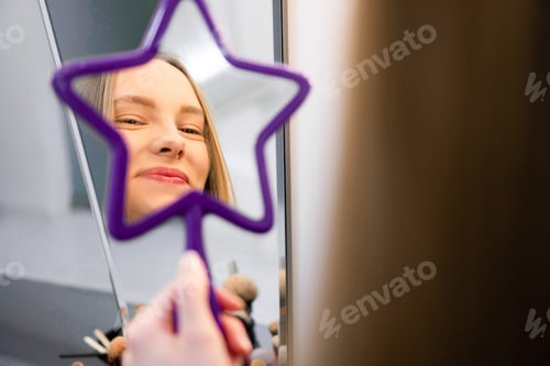 Preview: Young woman in a hand mirror reflection