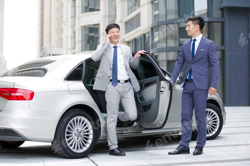 Preview: Confident businessman getting off car