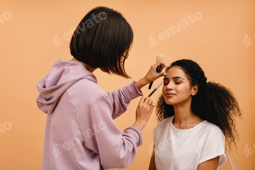 Preview: Professional stylist corrects makeup during photo shoot
