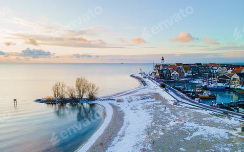 Preview: Lighthouse of Urk during winter with snow in the Netherlands. Dutch village in winter