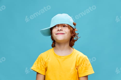 Preview: Child with a cap on his head and red hair smiling