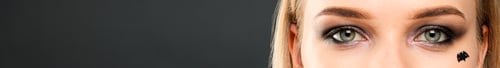 Preview: Close-up of girl's eyes with dark makeup and bat silhouette
