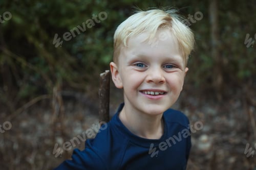 Preview: Adorable blonde Australian small boy smiling and looking at the camera