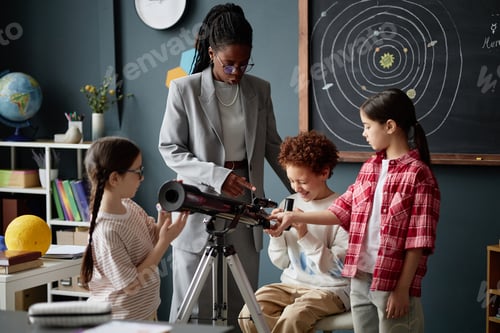 Preview: Black Woman Teaching Diverse Children Using Telescope in Classroom